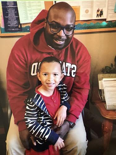 Man in red sweatshirt with his little daughter